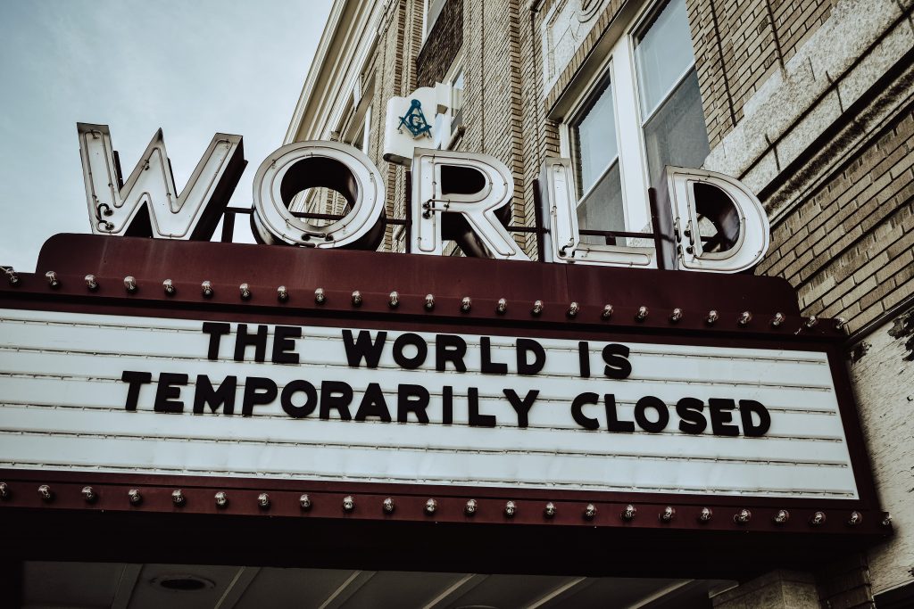 movie marquee reading "The world is temporarily closed."