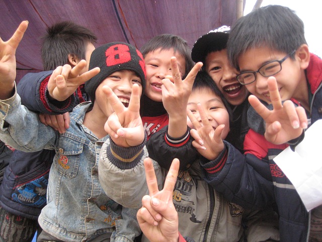 several children making peace signs with their hands