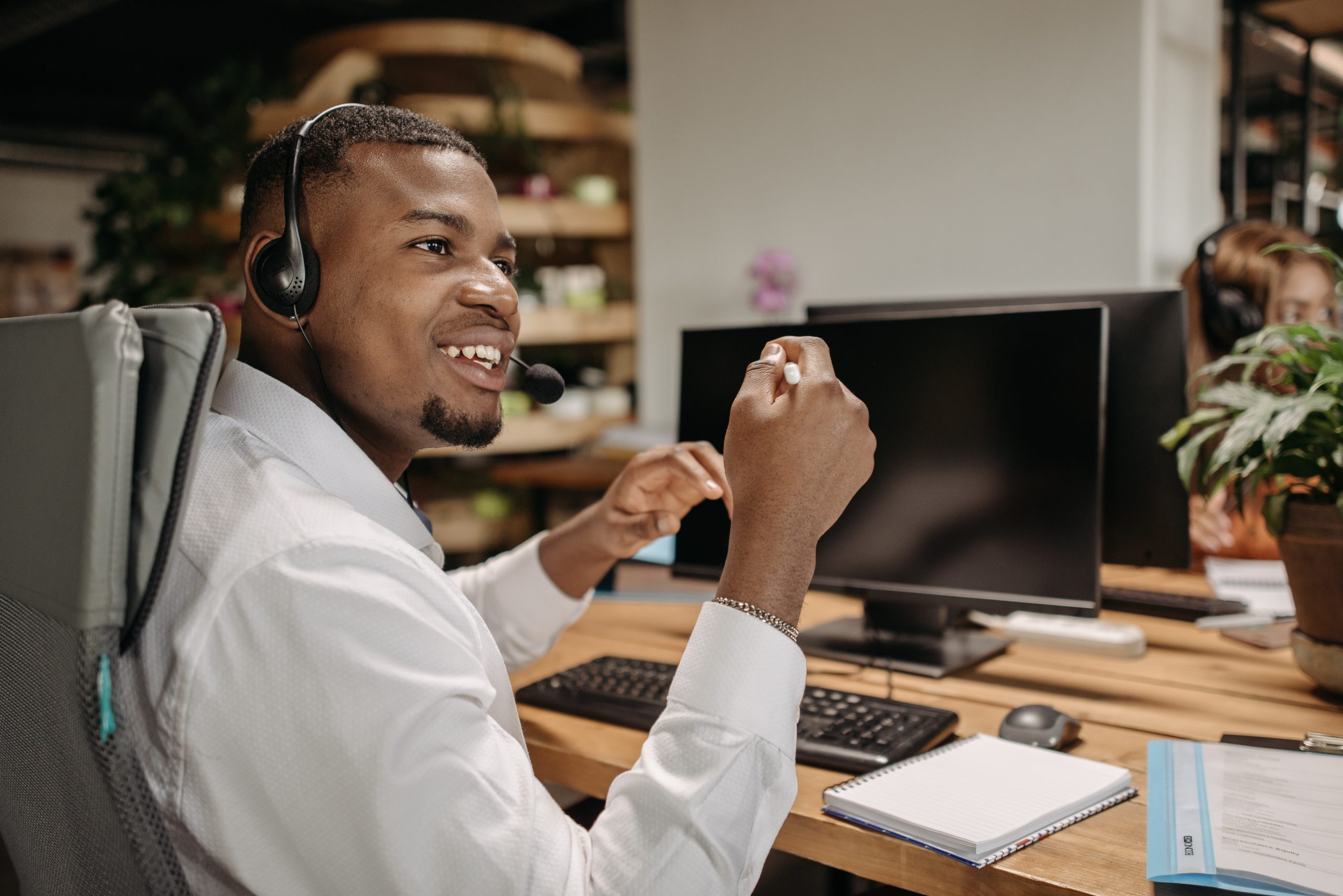 Photo of Contact Center Agent sitting at computer with headset